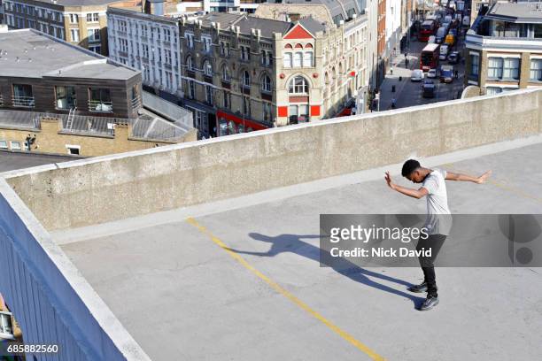 Young street dancer on London rooftop overlooking the city