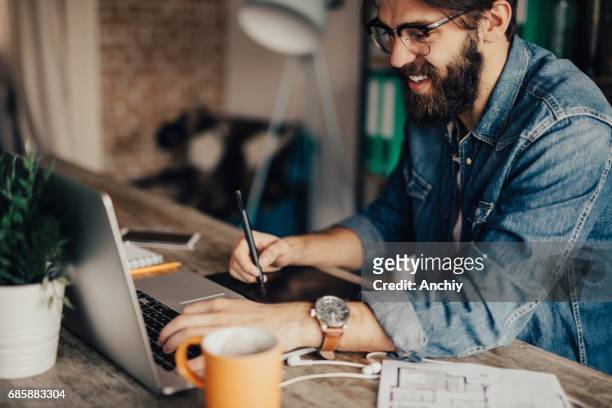 freelancer working at his home office - freelance work stock pictures, royalty-free photos & images