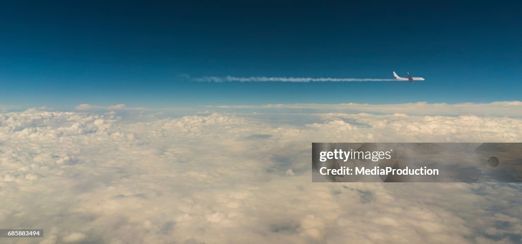 Airplane above clouds with copyspace