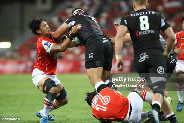 Yoshitaka Tokunaga of the Sunwolves tackles Thomas du Toit of the Sharks during the round 13 Super Rugby match between the Sunwolves and the Sharks...