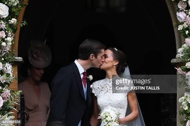 Pippa Middleton kisses her new husband James Matthews, following their wedding ceremony at St Mark's Church in Englefield, west of London, on May 20,...