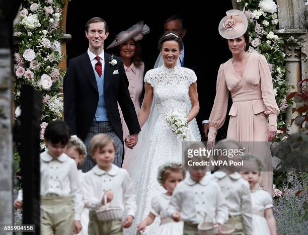 Pippa Middleton and James Matthews smile as they are joined by Catherine, Duchess of Cambridge, right, after their wedding at St Mark's Church onMay...