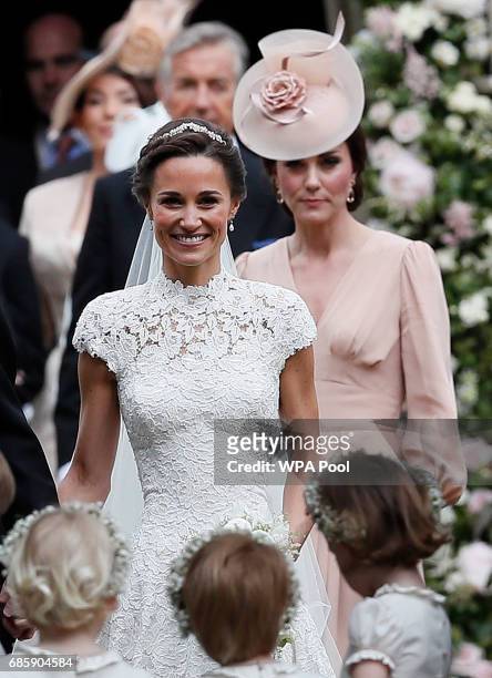 Catherine, Duchess of Cambridge, right, follows the bride, her sister Pippa Middleton, after her wedding to James Matthews at St Mark's Church on May...