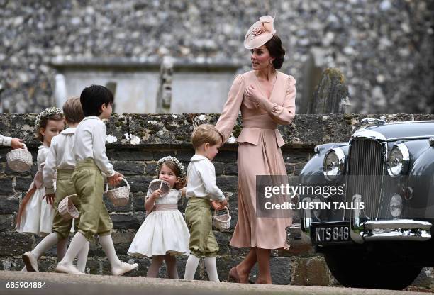 Britain's Catherine, Duchess of Cambridge beckons the bridesmaids and pageboys, including Britain's prince George and Britain's princess Charlotte...