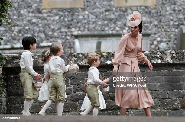 Catherine, Duchess of Cambridge, right, walks with the flower boys and girls after the wedding of Pippa Middleton and James Matthews at St Mark's...