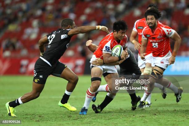 Yoshitaka Tokunaga of the Sunwolves attempts to go past Johan Deysel of the Sharks during the round 13 Super Rugby match between the Sunwolves and...