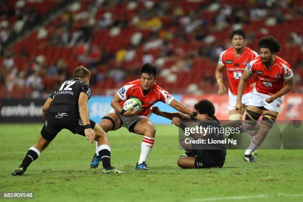 Yoshitaka Tokunaga of the Sunwolves attempts to go past Johan Deysel of the Sharks during the round 13 Super Rugby match between the Sunwolves and...