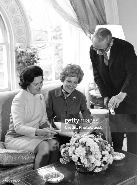 American First Lady Lady Bird Johnson looks over White House floor plans with incoming First Lady Pat Nixon and White House curator Clement Conger ,...