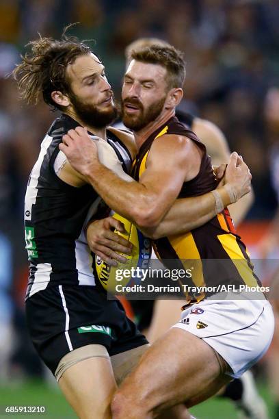 James Aish of the Magpies and Brendan Whitecross of the Hawks collide during the round nine AFL match between the Collingwood Magpies and the...