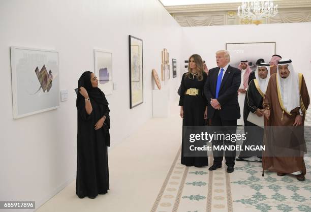 Saudi Arabia's King Salman bin Abdulaziz al-Saud , US President Donald Trump and US First Lady Melania Trump look at a display of Saudi modern art at...