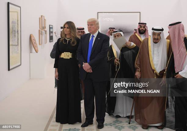 Saudi Arabia's King Salman bin Abdulaziz al-Saud , US President Donald Trump and US First Lady Melania Trump look at a display of Saudi modern art at...