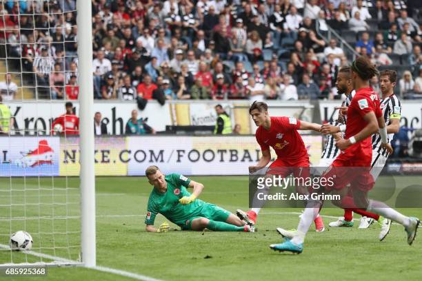 Marcel Sabitzer of Leipzig scores his team's first goal past goalkeeper Lukas Hradecky of Frankfurt during the Bundesliga match between Eintracht...