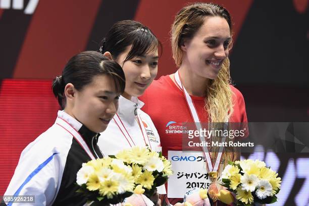 Sayuki Ouchi of Japan, Rikako Ikee of Japan and Alys Thomas of Great Britain pose with their medals on the podium after the 50m Butterfly Final...