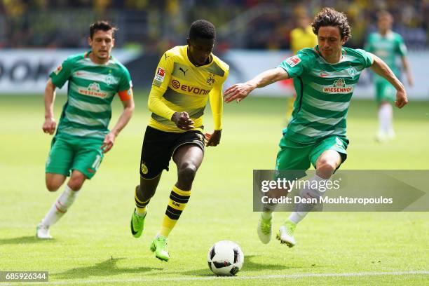 Ousmane Dembele of Borussia Dortmund gets past the tackle from Thomas Delaney and Zlatko Junuzovic of Werder Bremen during the Bundesliga match...