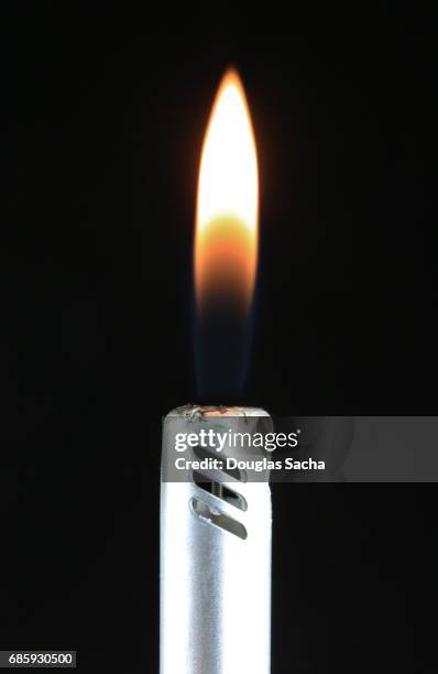 burning flame on a grille igniter - cigarette lighter stockfoto's en -beelden