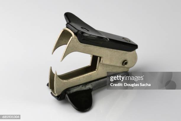 close-up of an office stapler remover on a white background - tacler stock-fotos und bilder