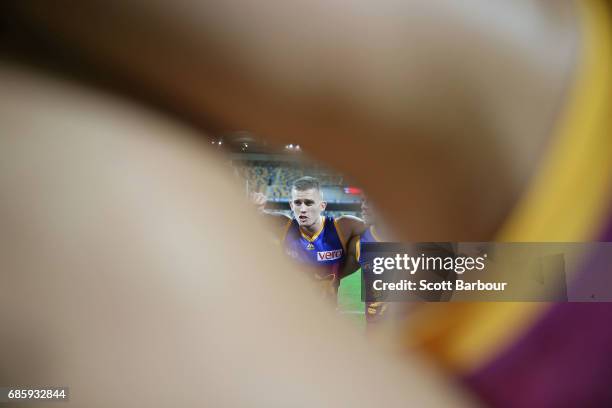 Dayne Beams of the Lions speaks to his teammates in a huddle during the round nine AFL match between the Brisbane Lions and the Adelaide Crows at The...