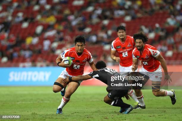 Yoshitaka Tokunaga of the Sunwolves is tackled by Garth April of the Sharks during the round 13 Super Rugby match between the Sunwolves and the...