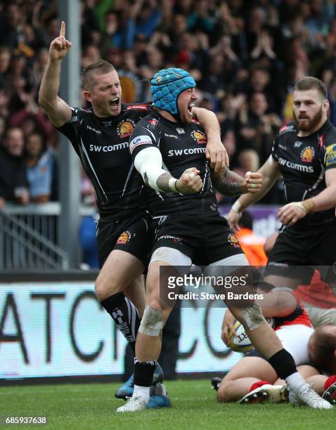 Jack Nowell of Exeter Chiefs celebrates with teammate Gareth Steenson after scoring the opening try during the Aviva Premiership semi final match...