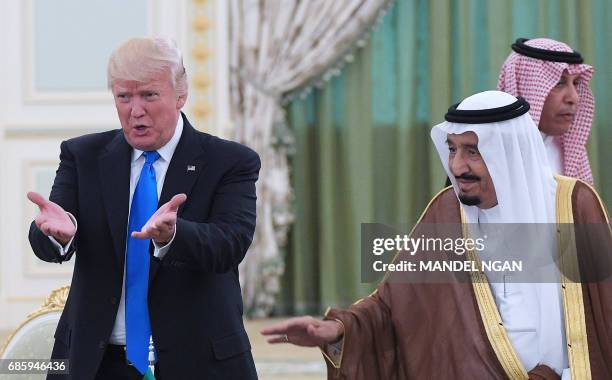 President Donald Trump and Saudi Arabia's King Salman bin Abdulaziz al-Saud gesture during a signing ceremony at the Saudi Royal Court in Riyadh on...