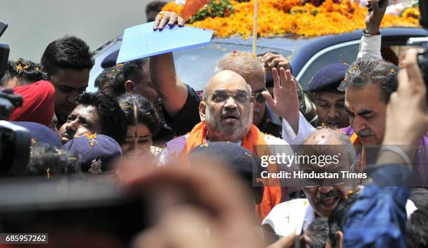 National President Amit Shah welcomed by the local leaders and supporters during the road show and inauguration of the newly-renovated hi-tech BJP...