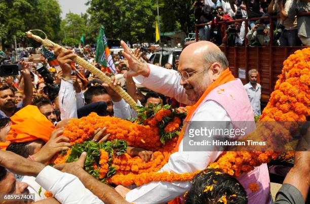 National President Amit Shah welcomed by the local leaders and supporters during the road show and inauguration of the newly-renovated hi-tech BJP...