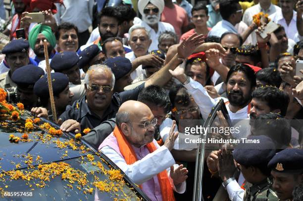 National President Amit Shah welcomed by the local leaders and supporters during the road show and inauguration of the newly-renovated hi-tech BJP...