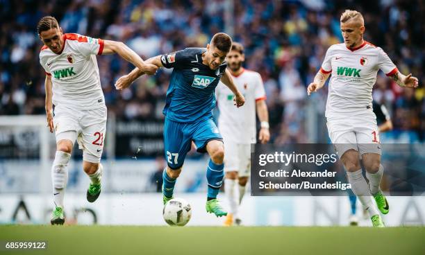 Dominik Kohr of Augsburg and Jonathan Schmid of Augsburg challenges Andrej Kramaric of Hoffenheim during the Bundesliga match between TSG 1899...