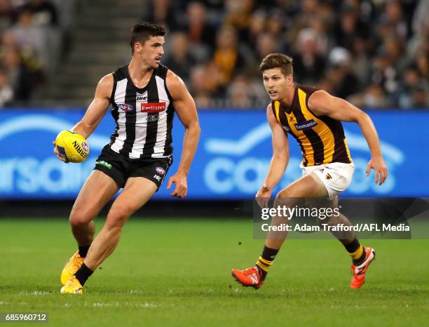 Scott Pendlebury of the Magpies in action ahead of Luke Breust of the Hawks during the 2017 AFL round 09 match between the Collingwood Magpies and...