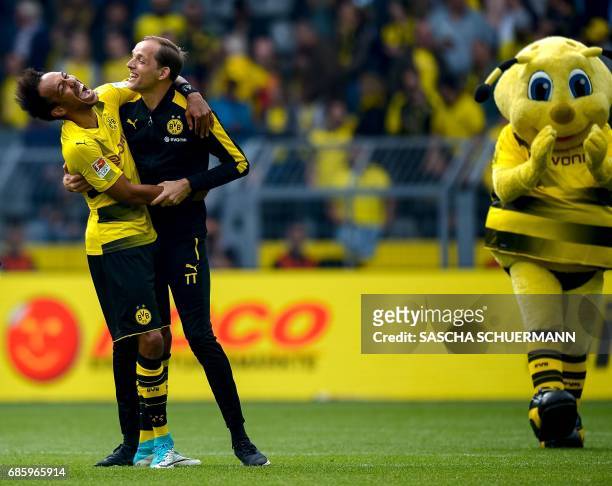 Dortmund's Gabonese forward Pierre-Emerick Aubameyang hugs Dortmund's head coach Thomas Tuchel after the German first division football match between...