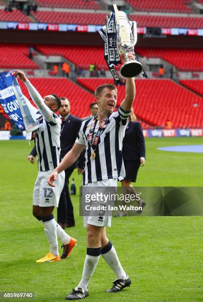 Captain Tony Craig of Millwall celebrates victory and promotion with the trophy after the Sky Bet League One Playoff Final between Bradford City and...