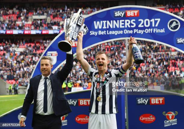 Neil Harris manager of Millwall and captain Tony Craig celebrate victory and promotion with the trophy after the Sky Bet League One Playoff Final...
