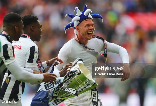 Aiden O'Brien of Millwall celebrates victory and promotion with the trophy and team mates after the Sky Bet League One Playoff Final between Bradford...