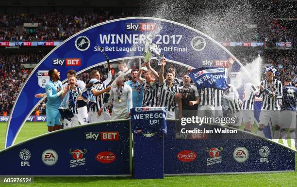 Millwall players celebrate victory and promotion with the trophy after the Sky Bet League One Playoff Final between Bradford City and Millwall at...