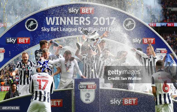 Millwall players celebrate victory and promotion with the trophy after the Sky Bet League One Playoff Final between Bradford City and Millwall at...