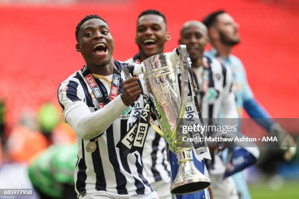 Fred Onyedinma of Millwall holds up the trophy during the Sky Bet League One Playoff Final between Bradford City and Millwall at Wembley Stadium on...