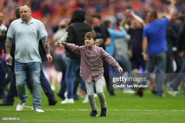 Millwall fans invade the pitch in celebration after the Sky Bet League One Playoff Final between Bradford City and Millwall at Wembley Stadium on May...