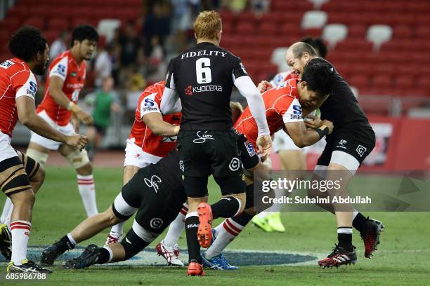 Lourens Adriaanse of Sharks tackles Yoshitaka Tokunaga of Sunwolves during the round 13 Super Rugby match between the Sunwolves and the Sharks at...