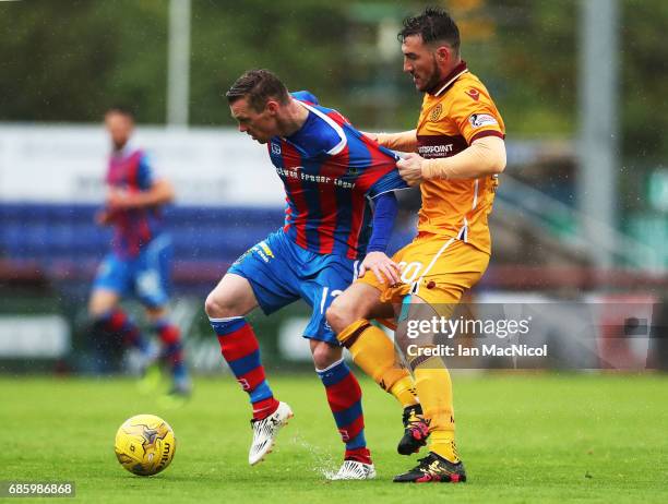 Billy McKay of Inverness Caledonian Thistle vies with Craig Clay of Motherwell during the Ladbrokes Premiership match between Inverness Caledonian...