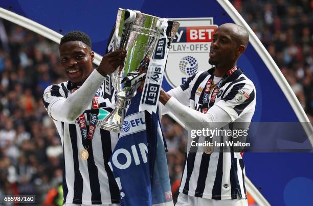 Fred Onyedinma and Nadjim Abdou of Millwall celebrate victory and promotion with the trophy after the Sky Bet League One Playoff Final between...