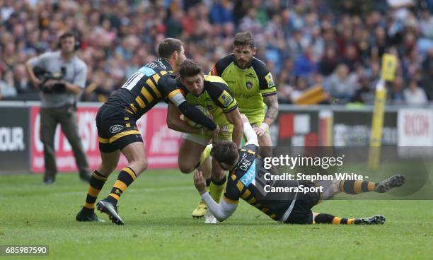 Leicester Tigers' Owen Williams is tackled by Wasps' Elliot Daly and Willie Le Roux during the Aviva Premiership match between Wasps and Leicester...