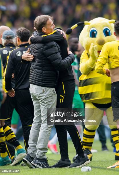Hans-Joachim Watzke, CEO of Borussia Dortmund, celebrates the win together with head coach Thomas Tuchel after the final whistle during the...