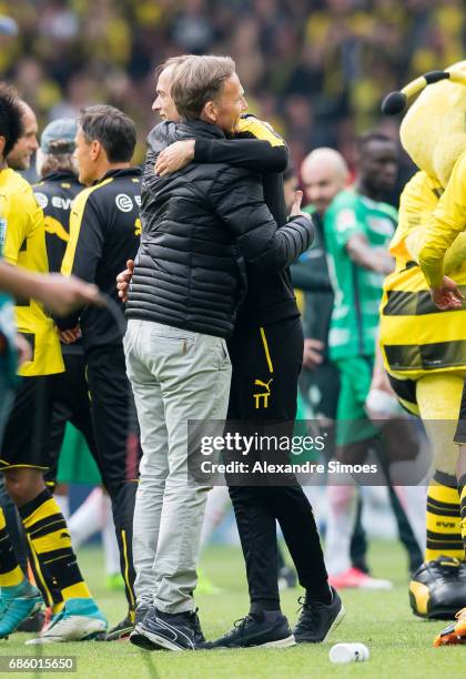 Hans-Joachim Watzke, CEO of Borussia Dortmund, celebrates the win together with head coach Thomas Tuchel after the final whistle during the...