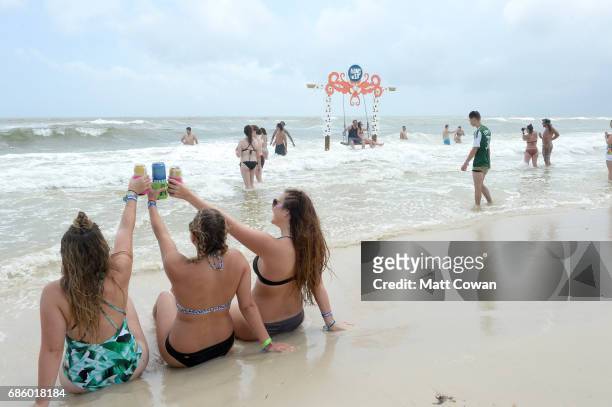 Festivalgoers sit in the ocean at the 2017 Hangout Music Festival on May 20, 2017 in Gulf Shores, Alabama.