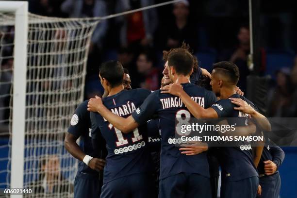 Paris Saint-Germain's players celebrate after scoring a goal during the French L1 football match between Paris Saint-Germain and SM Caen on May 20,...