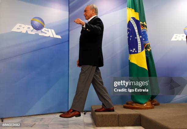 Brazilian President Michel Temer leaves after delivering a new statement following the release of a tape allegedly demonstrating him condoning...