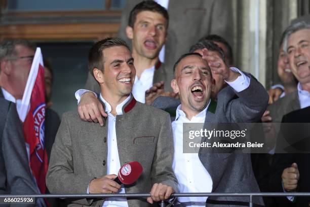 Philipp Lahm and Franck Ribery of Bayern Muenchen celebrate winning the 67th German Championship title on the town hall balcony at Marienplatz on May...