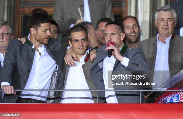 Xabi Alonso, Philipp Lahm and Franck Ribery of Bayern Muenchen celebrate winning the 67th German Championship title on the town hall balcony at...