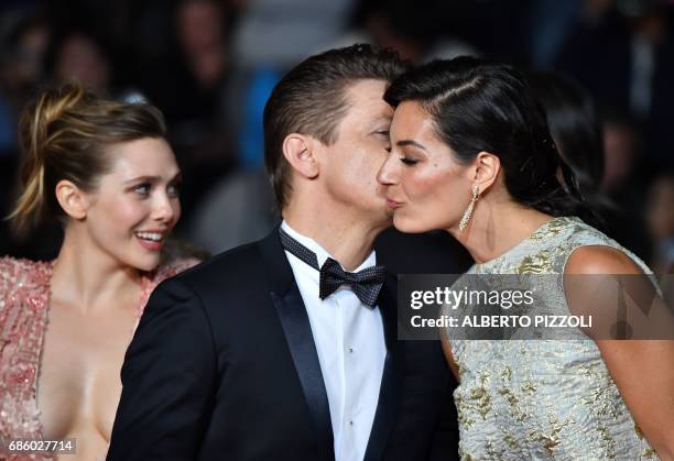 Actress Elizabeth Olsen, US actor Jeremy Renner and Nicole Sheridan, the wife of US director Taylor Sheridan arrive on May 20, 2017 for the screening...