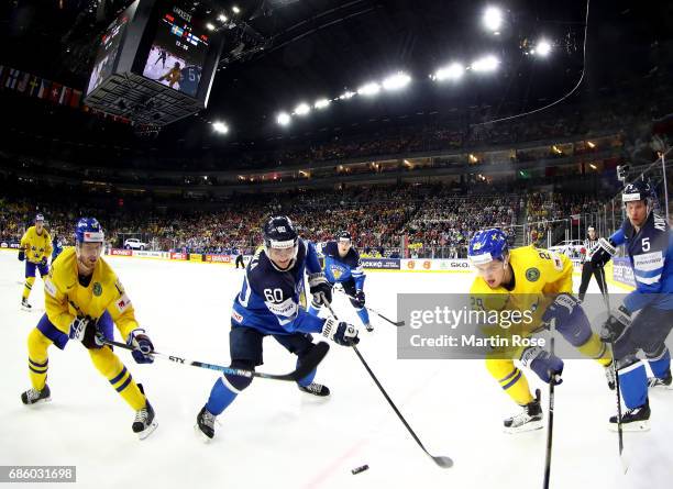 Oscar Lindberg of Sweden challenges Juhamatti Aaltonen of Finland for the puck during the 2017 IIHF Ice Hockey World Championship semi final game...